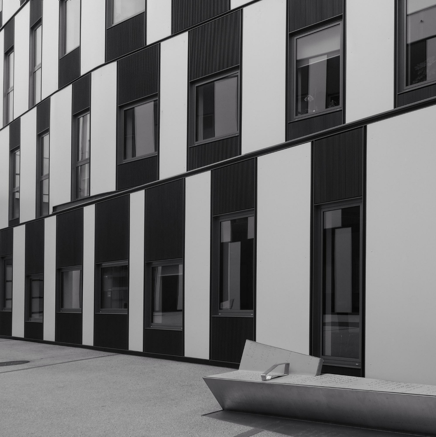 grayscale-shot-striped-apartment-building